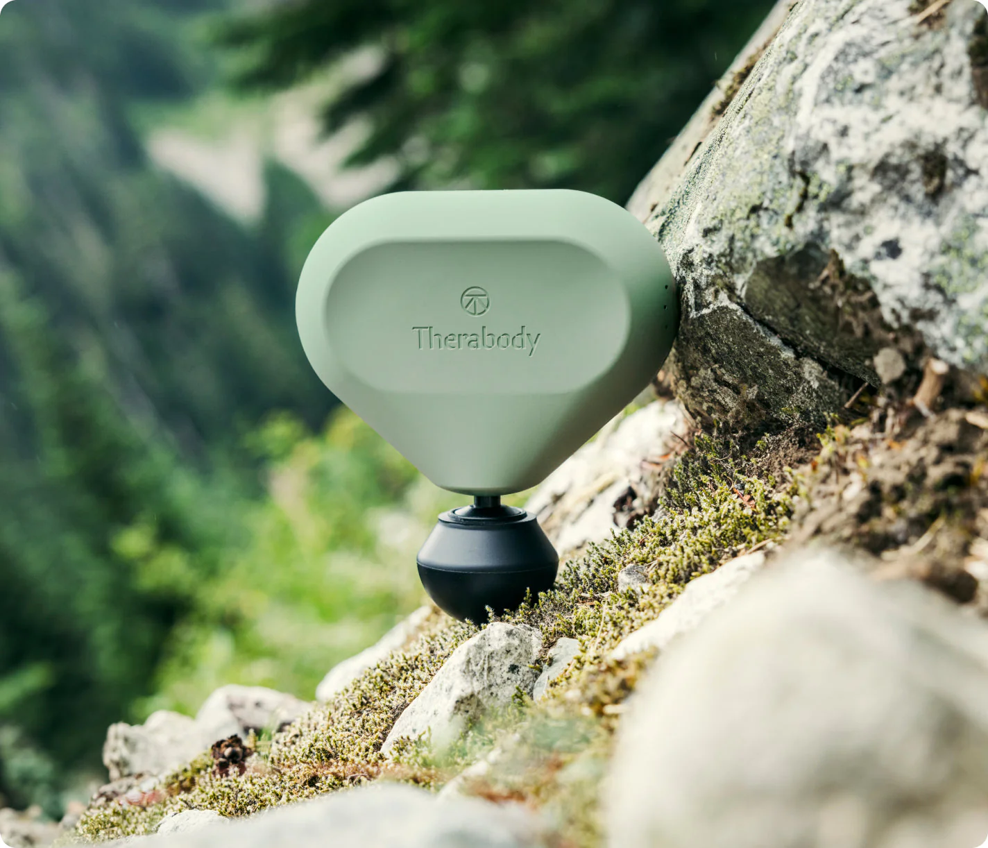 A compact white Theragun Mini portable percussion massager.