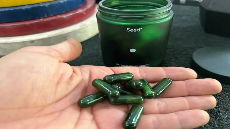 A handful of bright green Seed DS-01 capsules showing the nested technology.