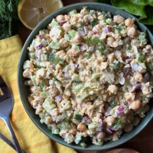 A macro shot of smashed chickpeas mixed with herbs and oils to create a tuna-like consistency.