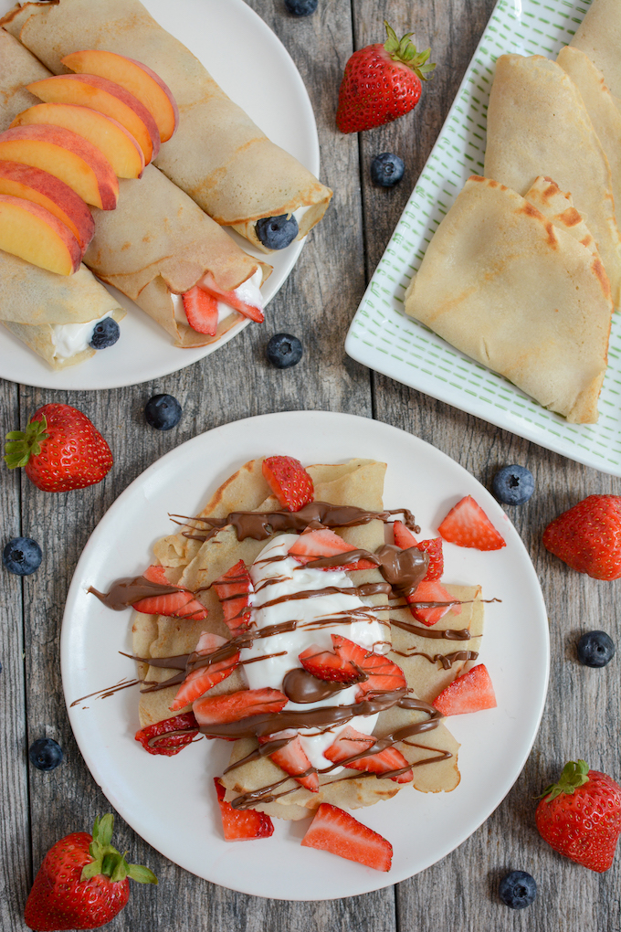 A clean stack of five plain gluten-free buckwheat crepes served on a white plate.