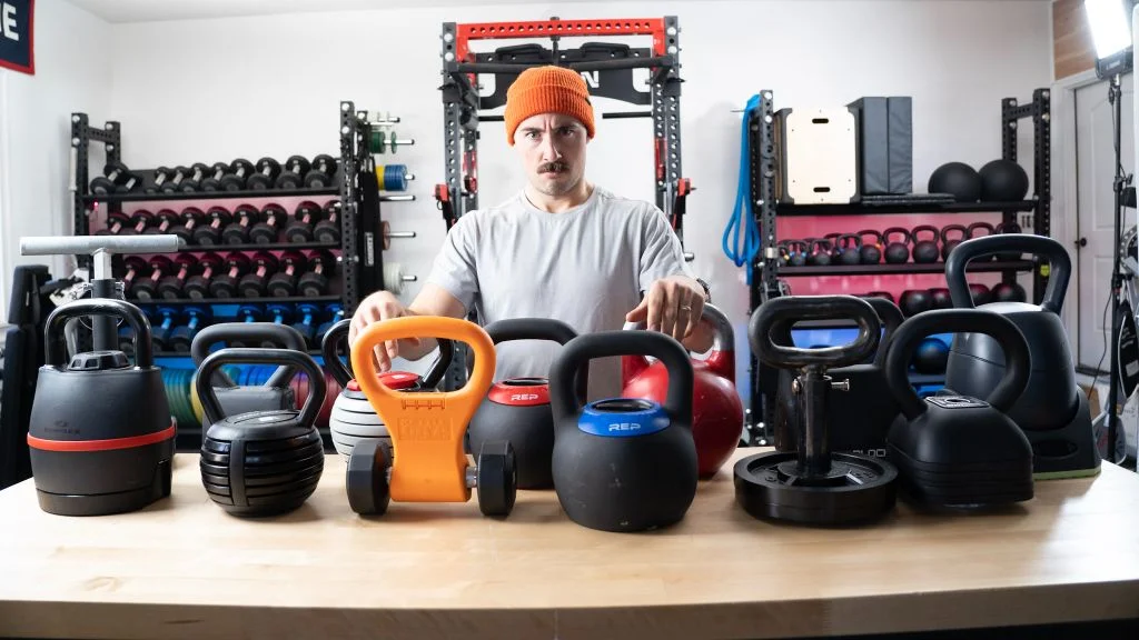 A collection of various kettlebells used for testing and comparison, including cast iron and competition styles.
