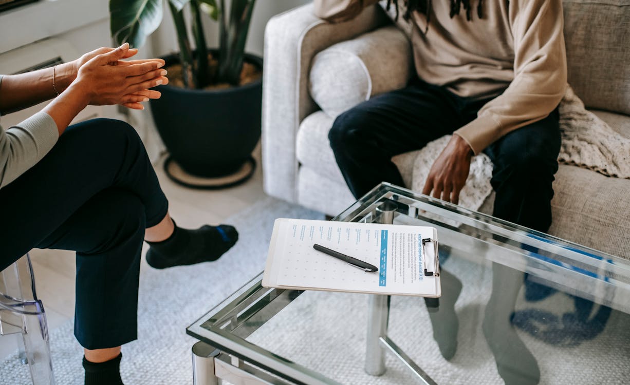 Two people engaged in a calm, focused conversation to resolve a conflict.