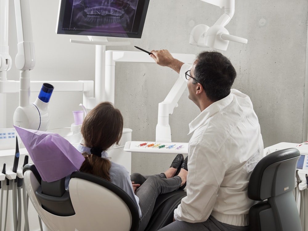 A dentist and patient discussing the systemic health links during a consultation