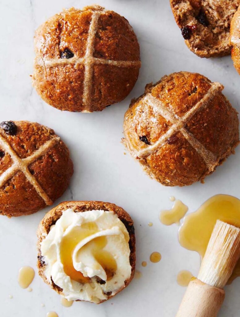 A batch of whole grain hot cross buns with icing crosses on top. (SEO: healthier whole grain hot cross buns recipes).