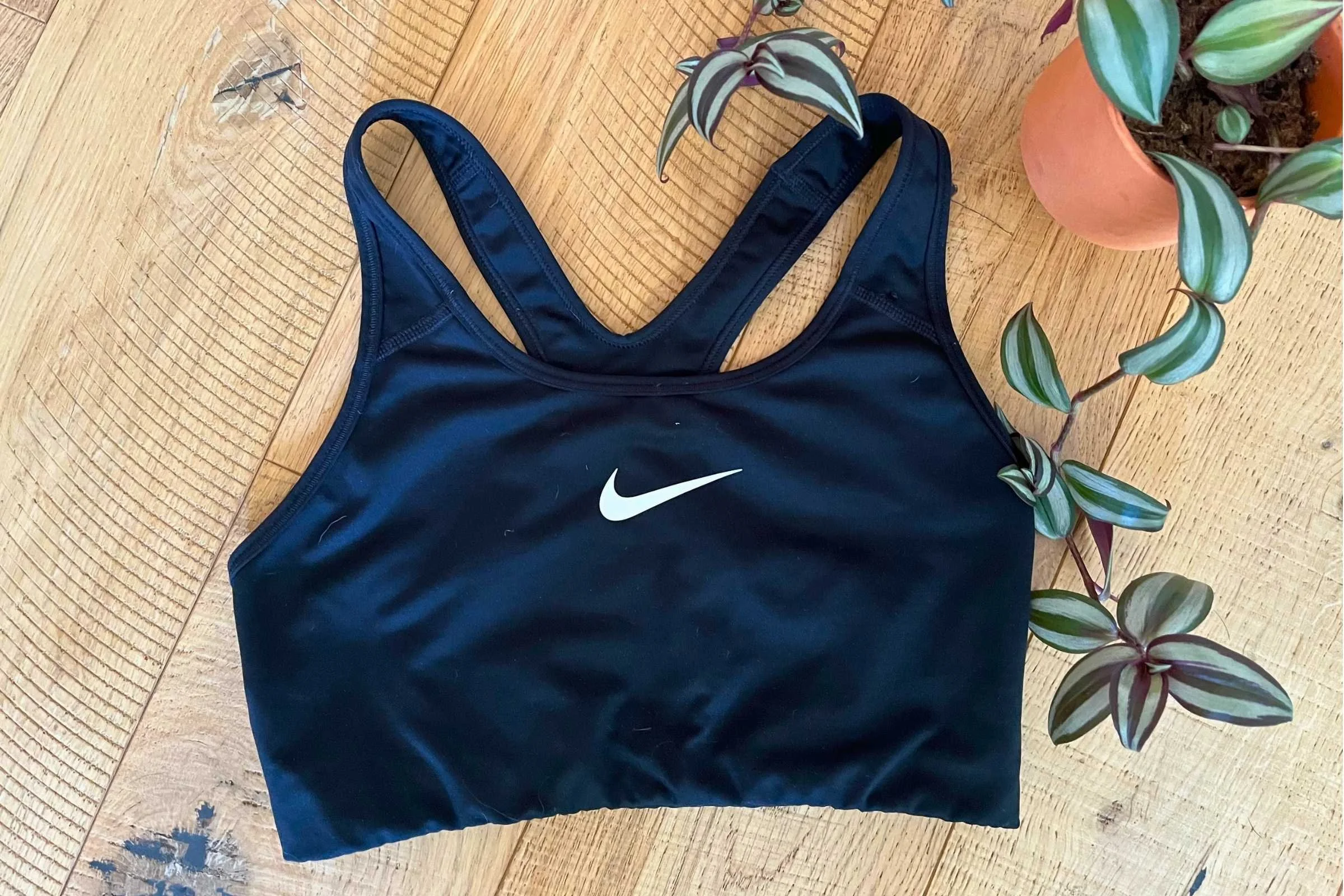 The classic Nike Swoosh sports bra in a light color.