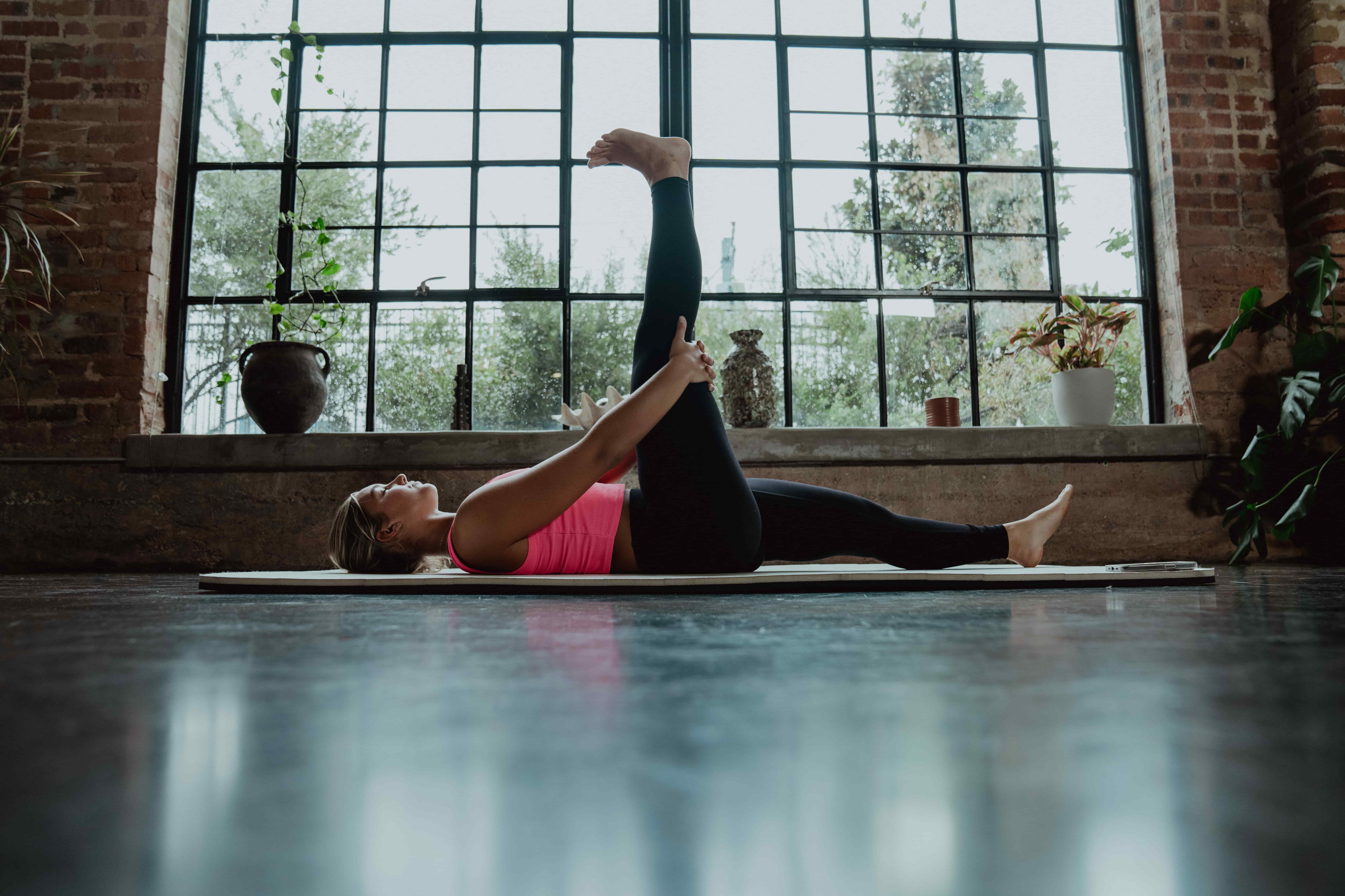 A woman performing dynamic speed training exercises outdoors.