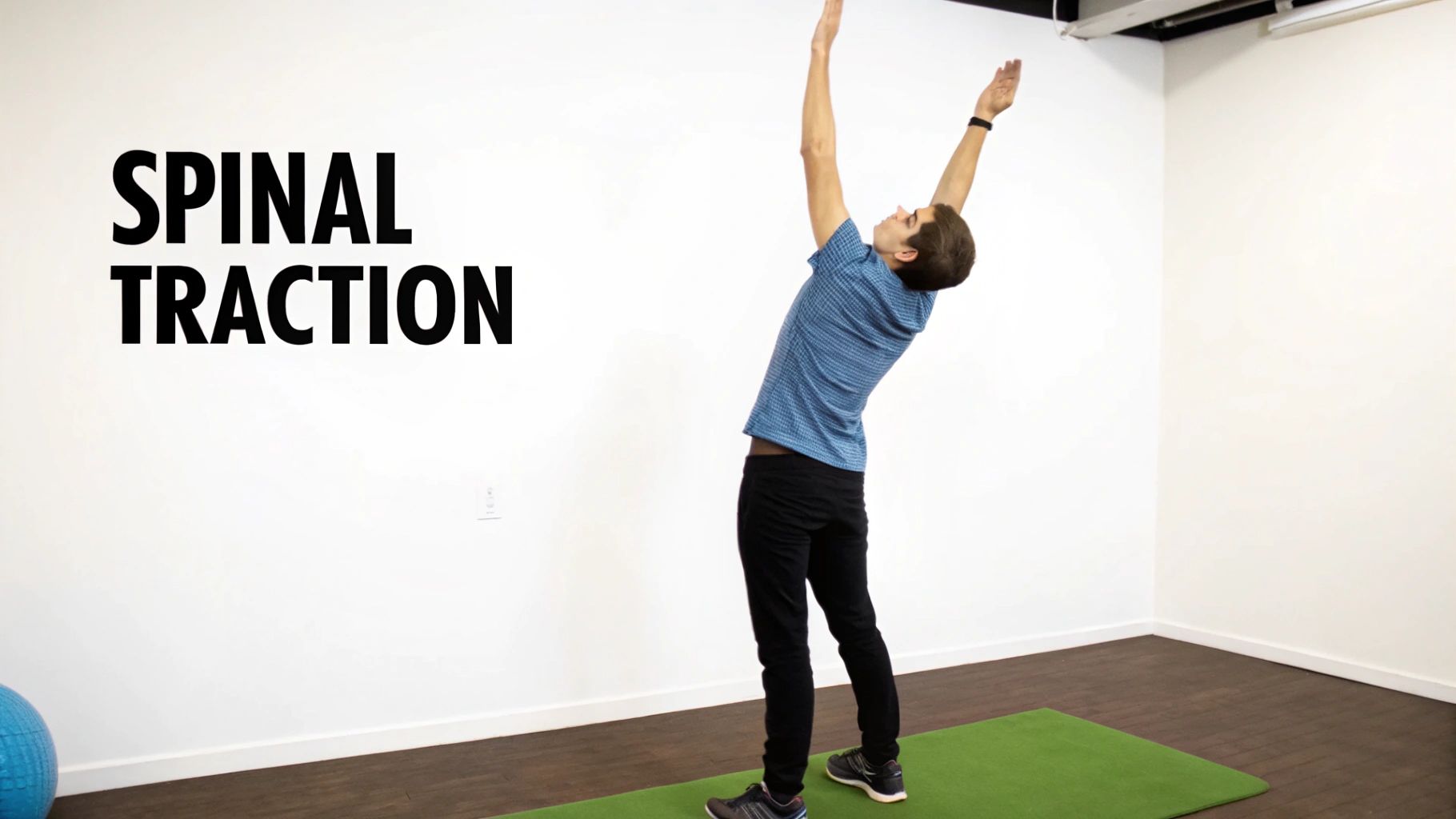 A man performing a standing spinal decompression stretch to elongate the lower back.